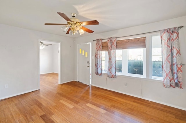 spare room with ceiling fan and light wood-type flooring