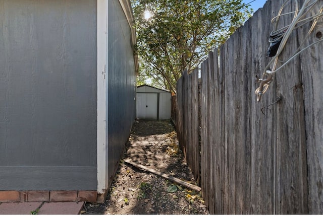 view of side of property featuring a storage shed