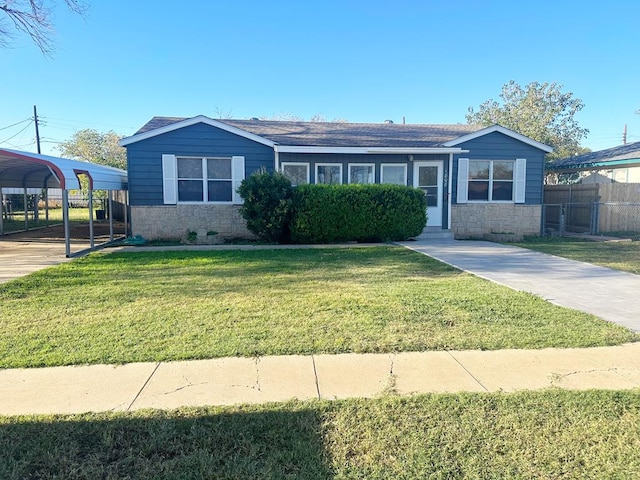 view of front of house with a front yard and a carport