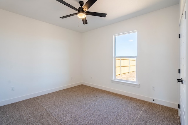 empty room with carpet flooring, ceiling fan, and baseboards