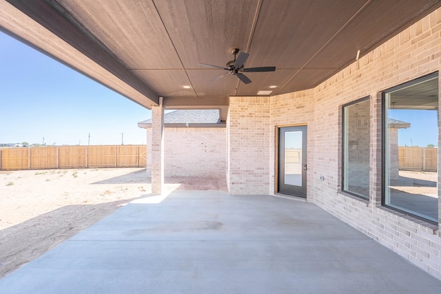 view of patio / terrace with ceiling fan and fence