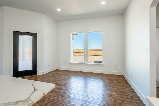 interior space with recessed lighting, dark wood-style flooring, and baseboards