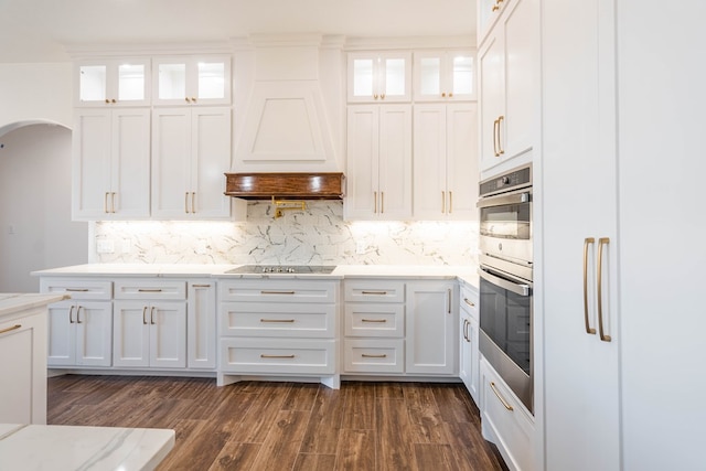 kitchen with glass insert cabinets, white cabinetry, and black electric cooktop