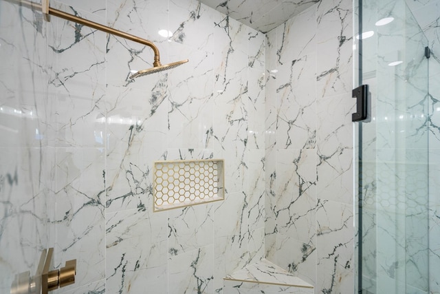 full bathroom featuring a marble finish shower