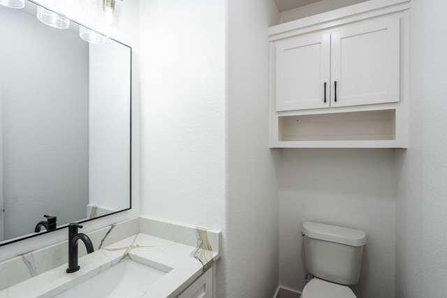 half bathroom with toilet and vanity