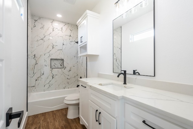 full bath featuring vanity, bathtub / shower combination, wood finished floors, and toilet