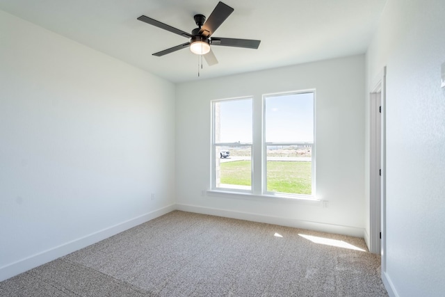 unfurnished room featuring carpet, baseboards, and a ceiling fan