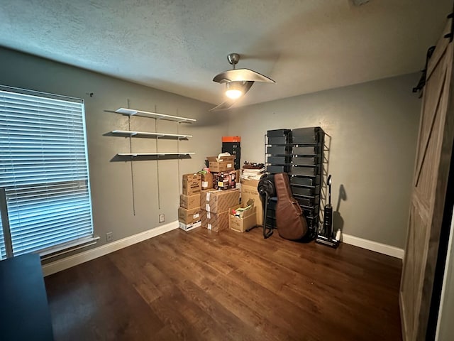 miscellaneous room with dark hardwood / wood-style flooring and a textured ceiling