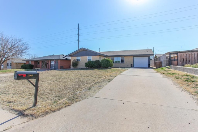 single story home featuring a garage and driveway