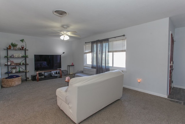 carpeted living area featuring visible vents, ceiling fan, and baseboards