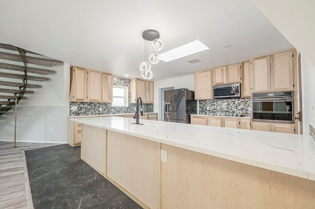 kitchen with tasteful backsplash, light stone counters, decorative light fixtures, stainless steel appliances, and light brown cabinetry