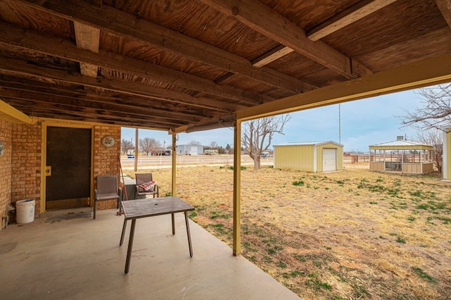 view of patio / terrace featuring an outdoor structure and fence