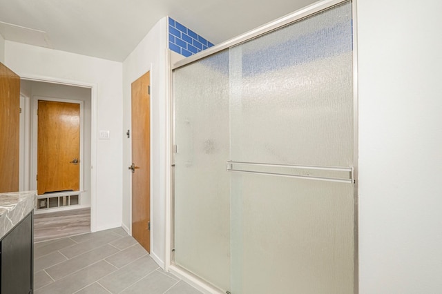 full bathroom with a shower stall and visible vents