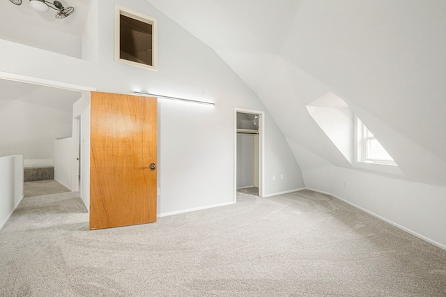 bonus room featuring carpet floors, vaulted ceiling, and baseboards