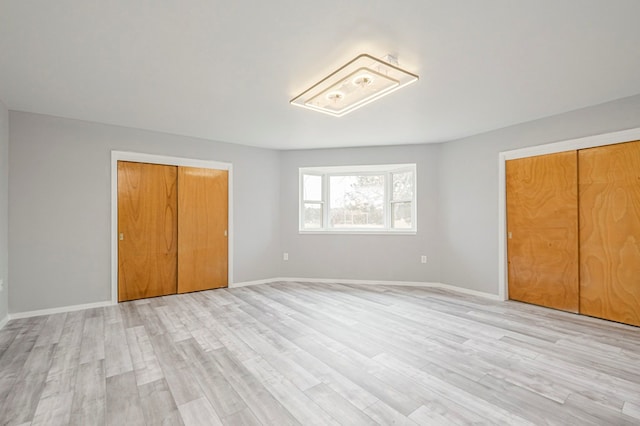 unfurnished bedroom with baseboards and light wood finished floors