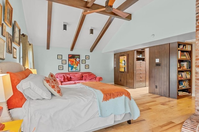 bedroom featuring ceiling fan, high vaulted ceiling, wood finished floors, and beam ceiling