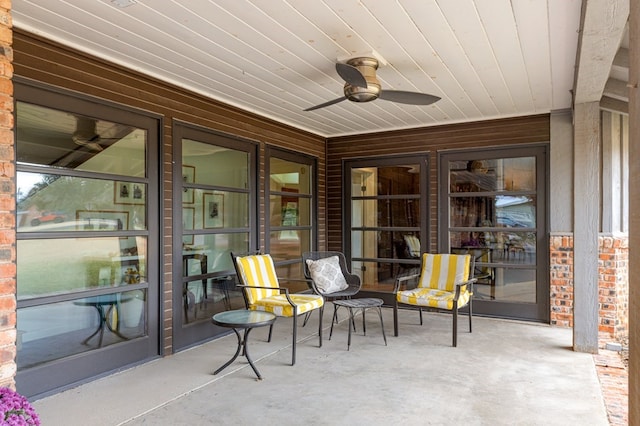 sunroom with ceiling fan and wooden ceiling