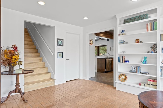 interior space featuring stairway, brick floor, and recessed lighting