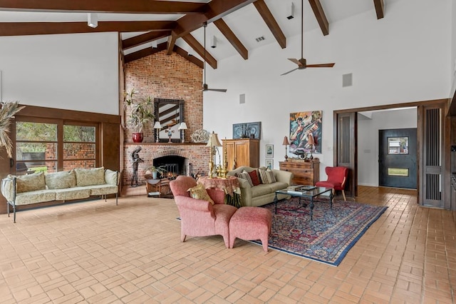 living room featuring ceiling fan, high vaulted ceiling, brick floor, a brick fireplace, and beam ceiling