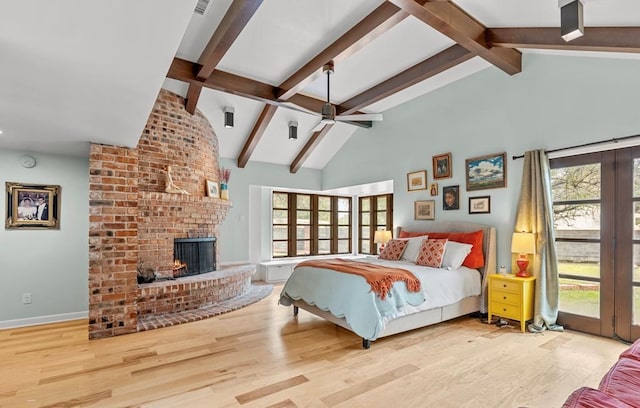 bedroom featuring high vaulted ceiling, a fireplace, wood finished floors, and beam ceiling