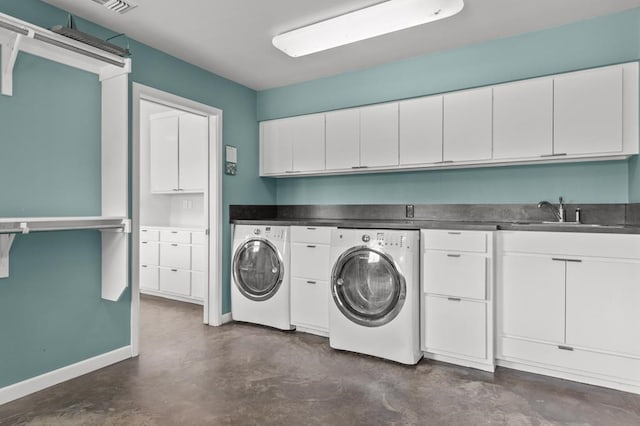 laundry area with separate washer and dryer, a sink, visible vents, baseboards, and cabinet space