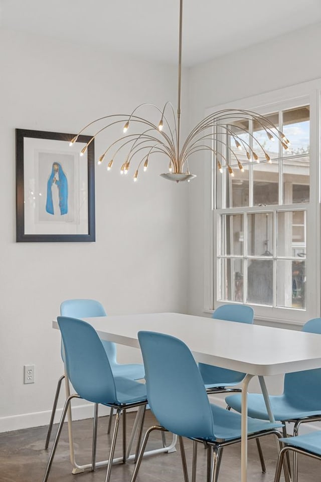 dining space featuring baseboards and wood finished floors