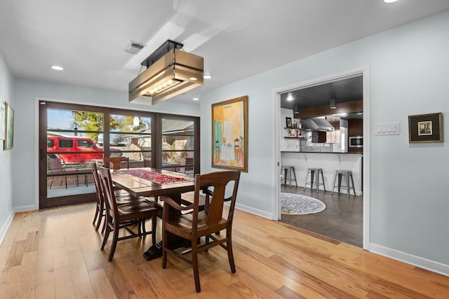 dining room with recessed lighting, visible vents, baseboards, and wood finished floors