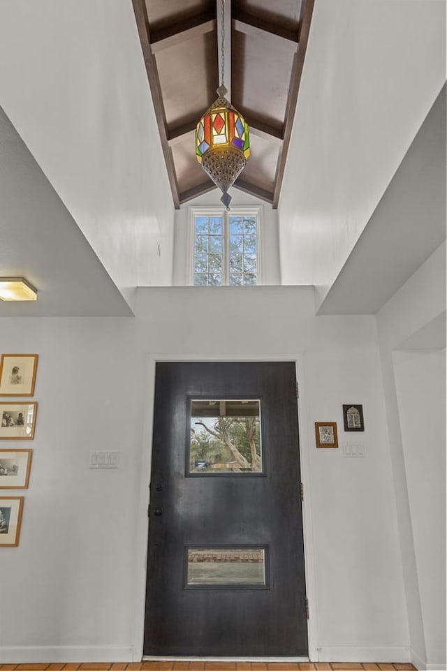 entryway with lofted ceiling with beams