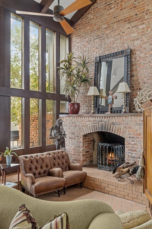 sunroom / solarium featuring lofted ceiling, a fireplace, and a ceiling fan