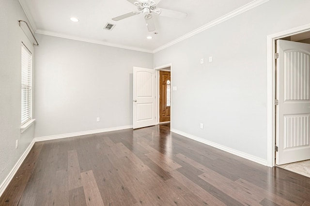 empty room featuring crown molding, wood finished floors, visible vents, and a ceiling fan