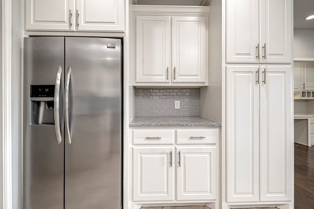 kitchen featuring wood finished floors, white cabinetry, tasteful backsplash, and stainless steel fridge with ice dispenser