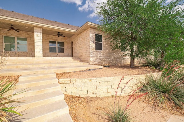 exterior space with a porch and ceiling fan