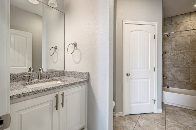 bathroom with tile patterned floors, shower / bathtub combination, and vanity