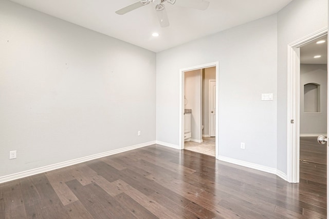 interior space with connected bathroom, baseboards, wood finished floors, and recessed lighting