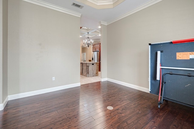 interior space featuring an inviting chandelier, baseboards, visible vents, ornamental molding, and hardwood / wood-style flooring