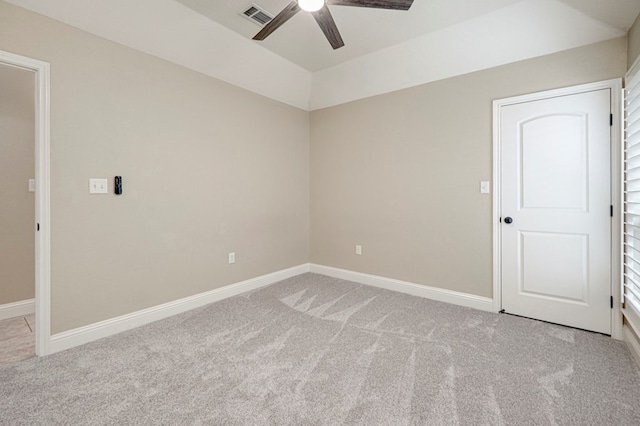 spare room with visible vents, a ceiling fan, baseboards, and light colored carpet