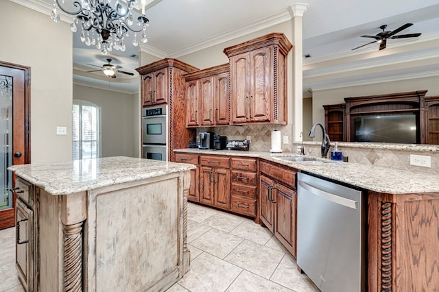 kitchen featuring crown molding, ceiling fan, a sink, stainless steel appliances, and decorative backsplash