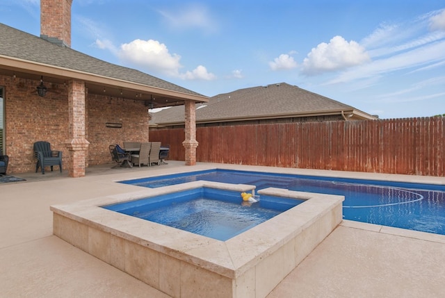 view of pool featuring a fenced backyard, a fenced in pool, a ceiling fan, a patio area, and an in ground hot tub