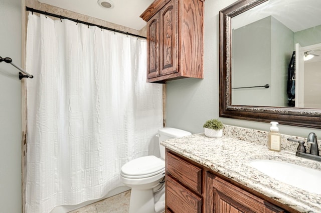 bathroom featuring toilet, curtained shower, and vanity
