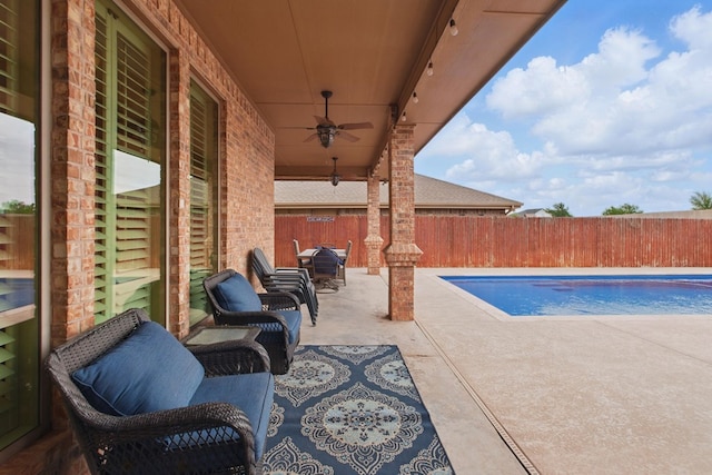 view of swimming pool featuring a fenced in pool, a ceiling fan, a fenced backyard, and a patio area