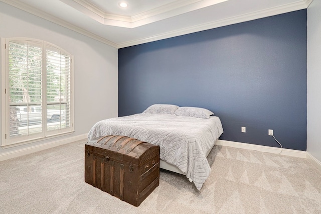 bedroom with crown molding, baseboards, carpet flooring, and a raised ceiling