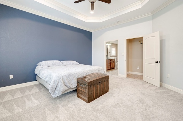 bedroom featuring a raised ceiling, ornamental molding, light carpet, and baseboards