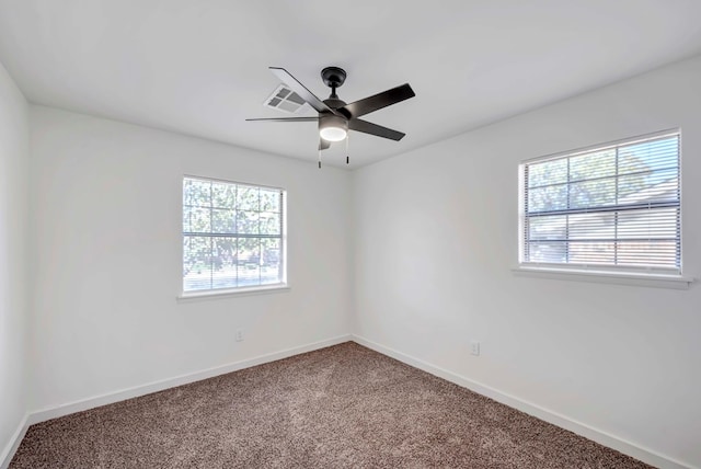 carpeted spare room with ceiling fan