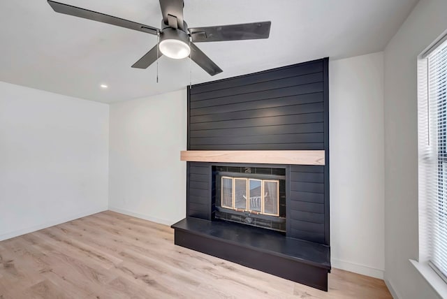 details with a fireplace, wood-type flooring, and ceiling fan