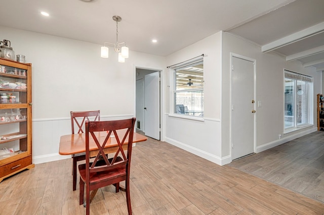 dining room with recessed lighting, baseboards, an inviting chandelier, and light wood-style floors