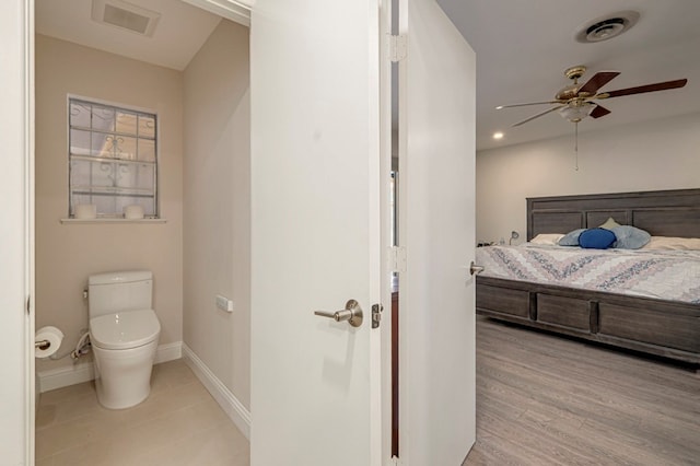 bathroom featuring baseboards, visible vents, ceiling fan, and toilet