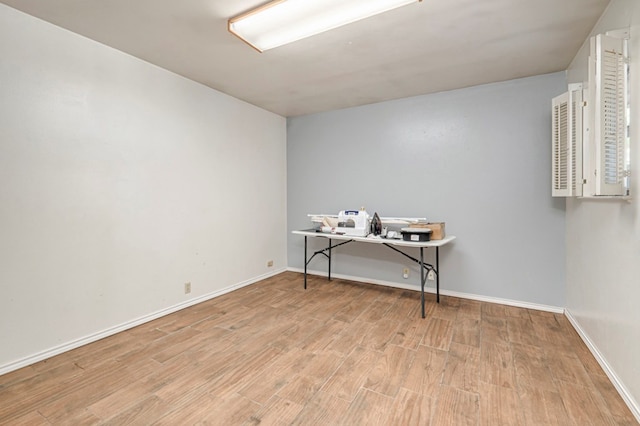 interior space with baseboards and wood finished floors
