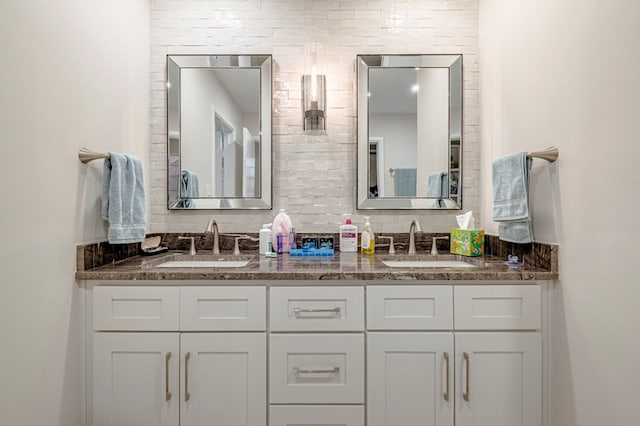 full bath featuring double vanity and a sink