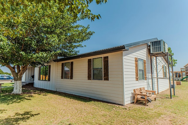 view of property exterior featuring a yard and central air condition unit