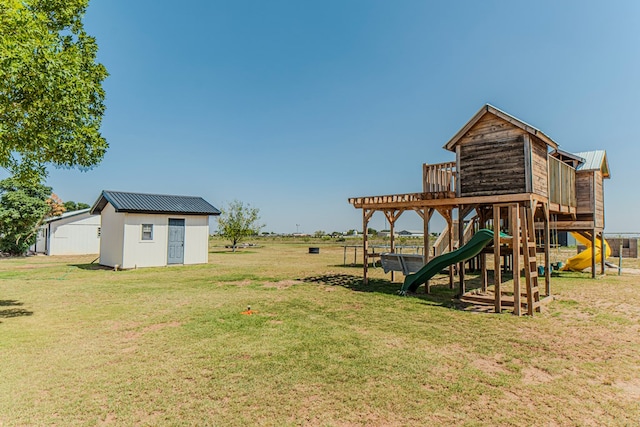 view of jungle gym featuring a lawn and a shed